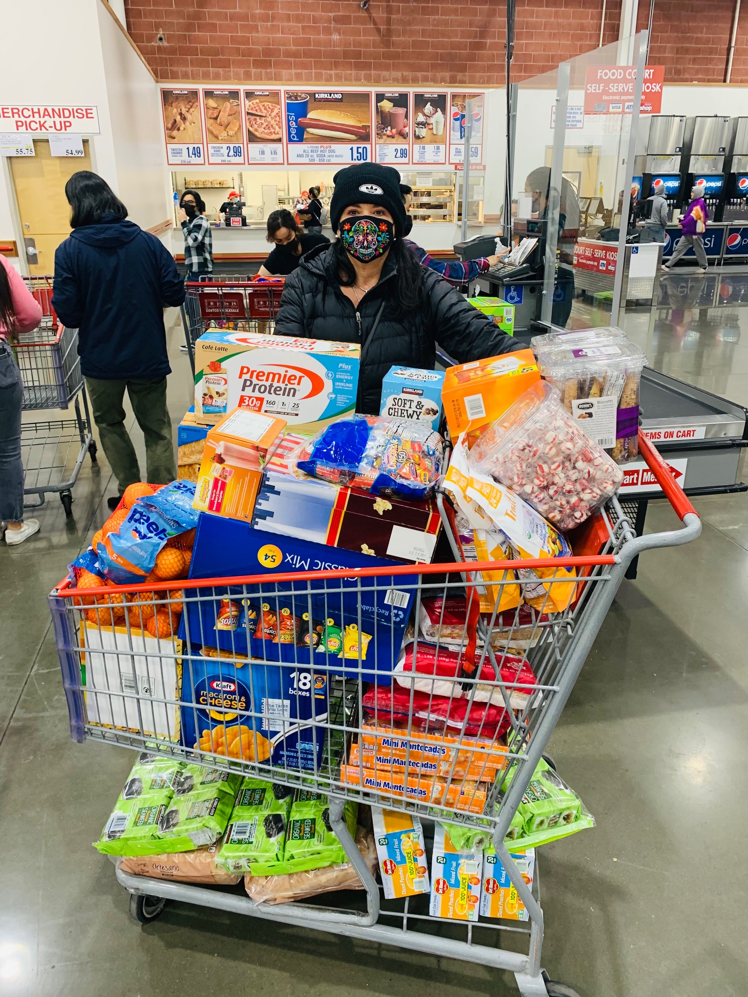 Cal NERDS Director Diana Lizarraga shopping for our Cal NERDS Micro-Food Pantry, the 'cube'